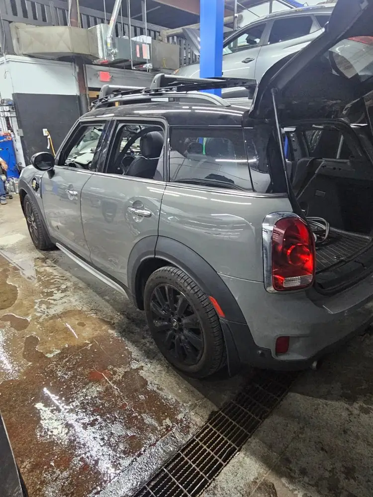 Compact SUV in the bay for repair, hatch open