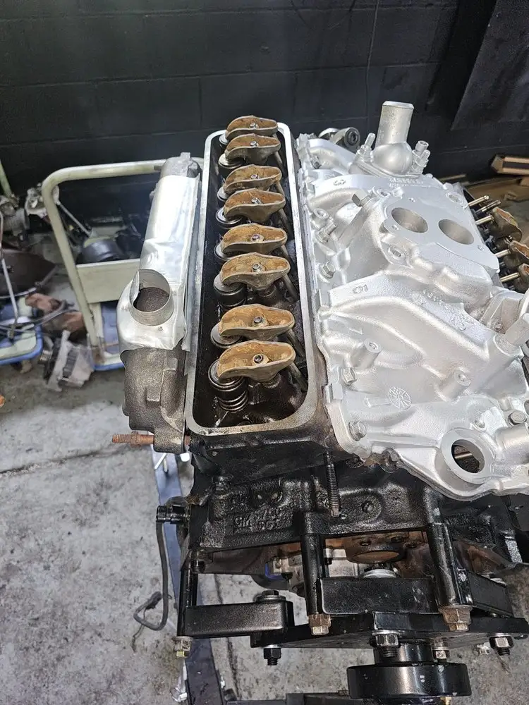 Engine block with new pistons during a rebuild